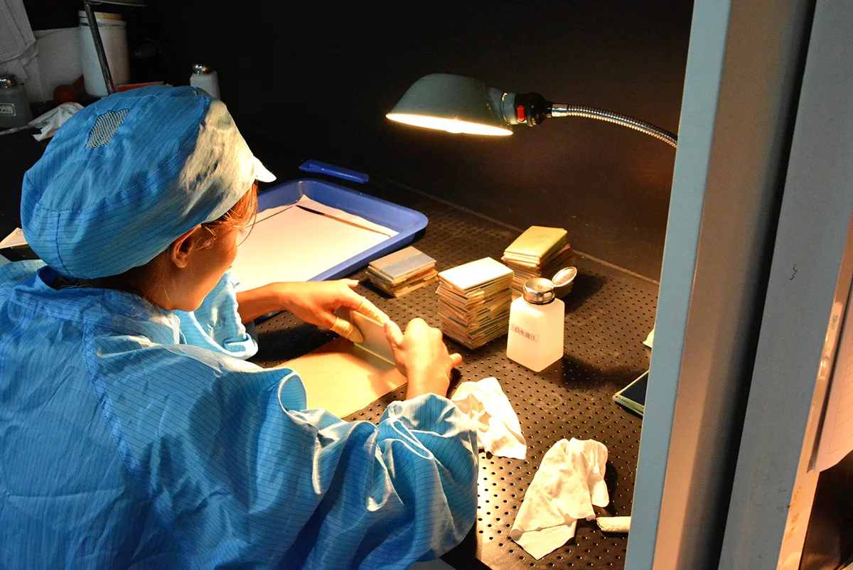 GIAI technician packaging inspected optical components