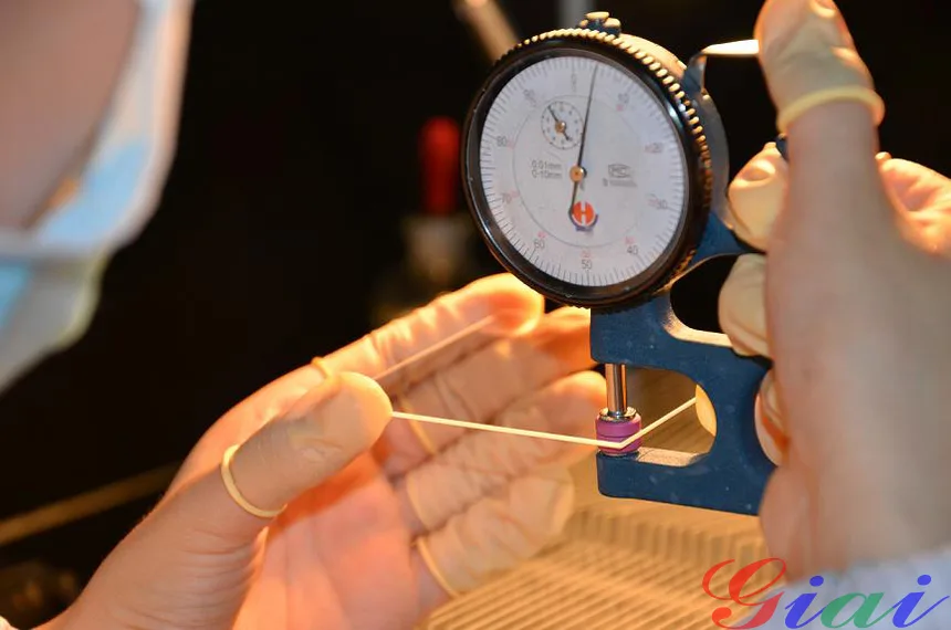 GIAI technician measuring an optical substrate before coating